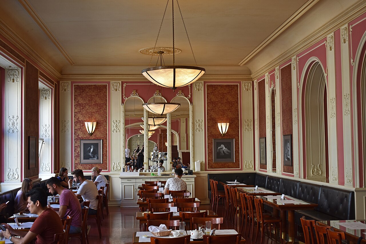 The historic marble-and-mirror interior of Café Louvre in Prague